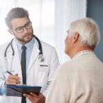 An older man discusses prostate cancer screening with his doctor | Corporate Synergies