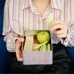 Woman Holding Lunch Box for Workplace Mental Health | Corporate Synergies