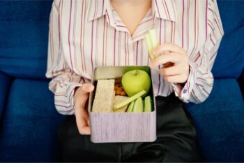 Woman Holding Lunch Box for Workplace Mental Health | Corporate Synergies