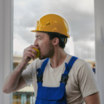 Construction worker having a break and eating apple | Corporate Synergies