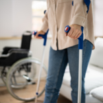 Person using crutches near wheelchair at home needs guide to STD benefits | Corporate Synergies