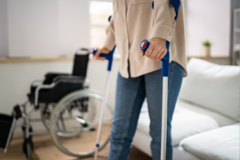 Person using crutches near wheelchair at home needs guide to STD benefits | Corporate Synergies