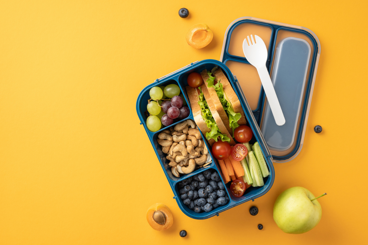 Lunchbox packed with healthy foods like fruits, vegetables, nuts, sandwich for daily nutrition | Corporate Synergies
