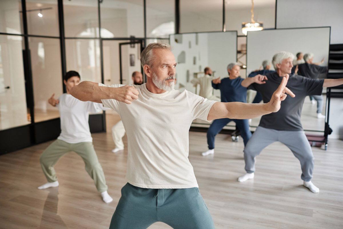 Senior man in tai chi class as an alternative therapy for stress | Corporate Synergies
