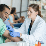 Patient receiving vaccine with health insurance | Corporate Synergies