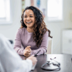 Young woman at health appointment with health insurance after age 26 | Corporate Synergies