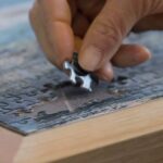 Older man completing a jigsaw puzzle for healthy aging | Corporate Synergies