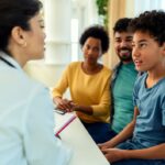 2026- African American boy getting a preventive care screening by a female pediatrician | Corporate Synergies