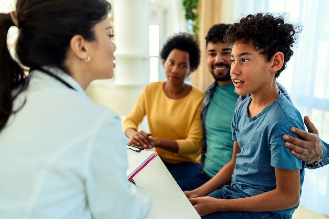 2026- African American boy getting a preventive care screening by a female pediatrician | Corporate Synergies