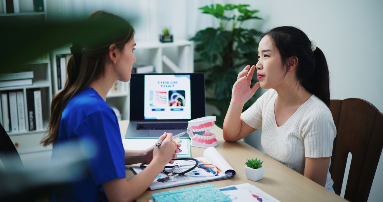 Female teen listening consulting with dentist for preventive health and wellness care | Corporate Synergies