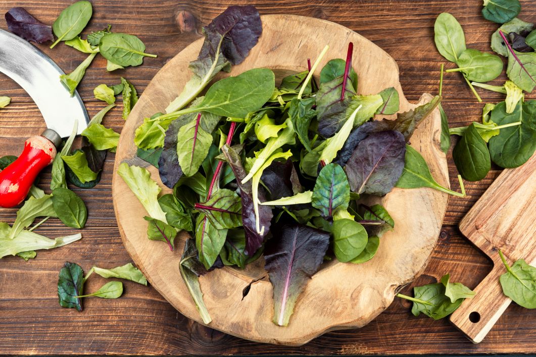 Leafy green superfood salad with spinach, arugula, romaine and lettuce in rustic wooden bowl | Corporate Synergies