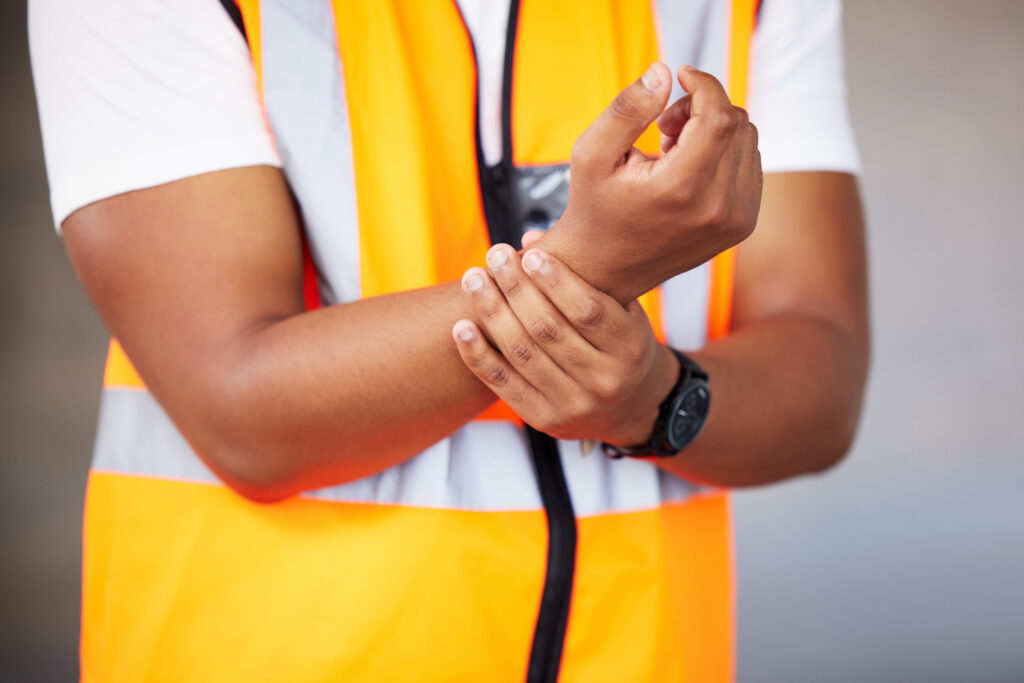 worker with workplace injury pain in his wrist | Corporate Synergies