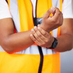 worker with workplace injury pain in his wrist | Corporate Synergies