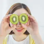 girl with superfood kiwi covering her eyes | Corporate Synergies